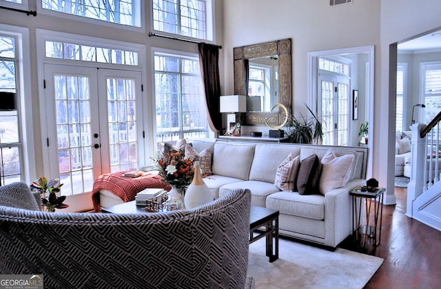 living room featuring visible vents, french doors, dark wood finished floors, and a wealth of natural light