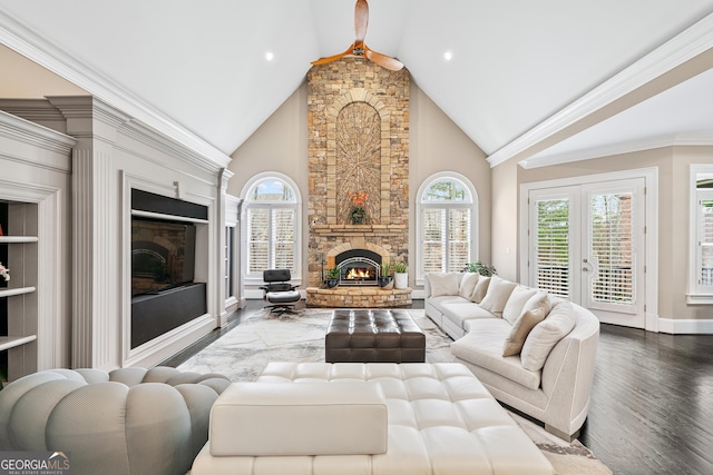 8760 Colonial Pl, Duluth, GA 30097 - living area featuring a stone fireplace, plenty of natural light, wood finished floors, high vaulted ceiling, and baseboards