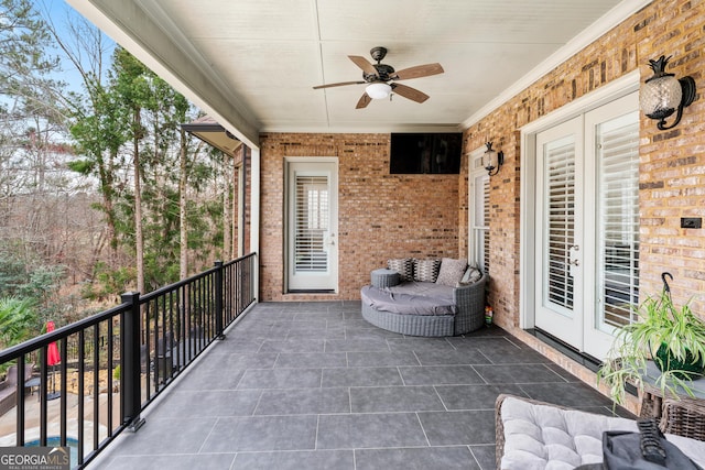 balcony with ceiling fan and french doors