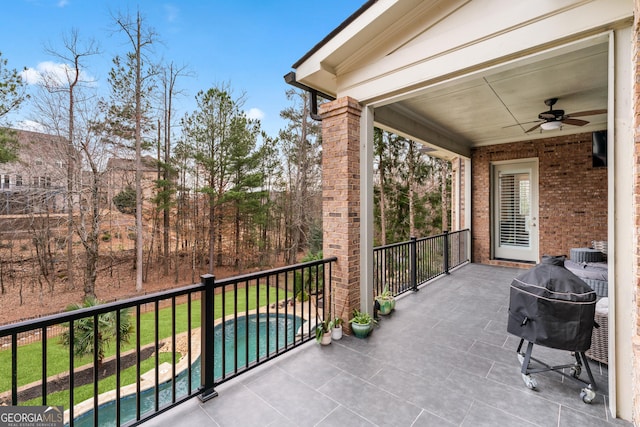 balcony featuring a patio area, a grill, and ceiling fan