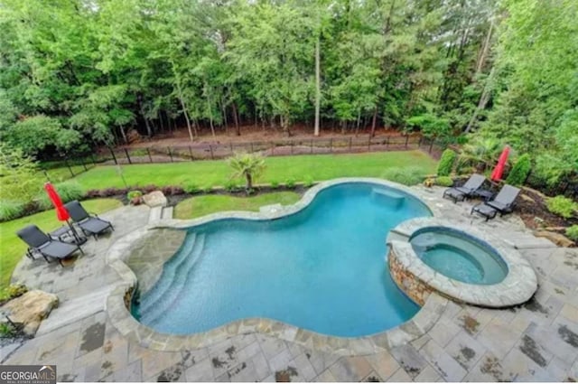 8760 Colonial Pl, Duluth, GA 30097 - view of swimming pool featuring a patio area, a pool with connected hot tub, fence, and a lawn