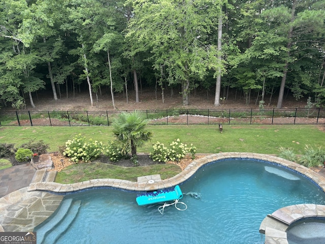 view of pool featuring a fenced in pool, an in ground hot tub, a yard, and fence