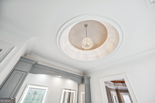 interior details featuring crown molding and a notable chandelier