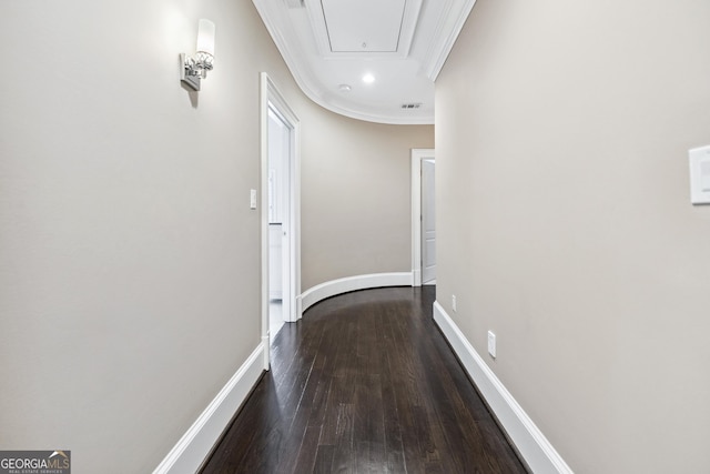 hall featuring dark wood-style flooring, crown molding, recessed lighting, attic access, and baseboards