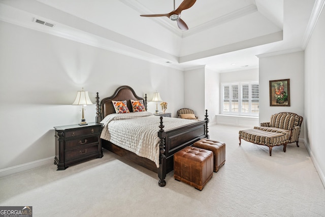 carpeted bedroom with baseboards, a raised ceiling, and crown molding