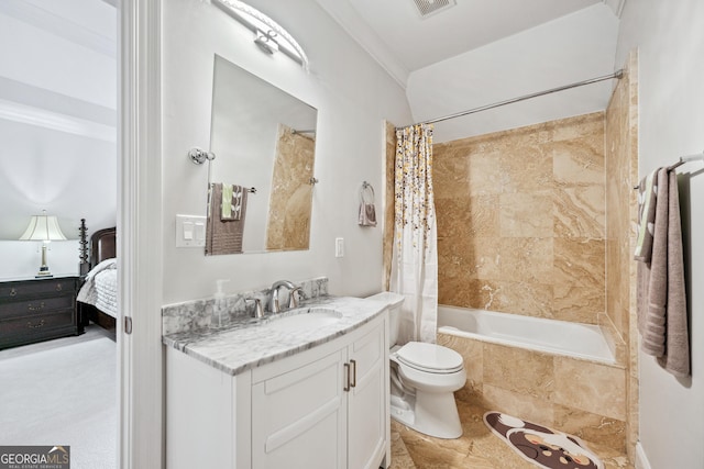 ensuite bathroom with visible vents, toilet, ensuite bath, tiled shower / bath combo, and vanity