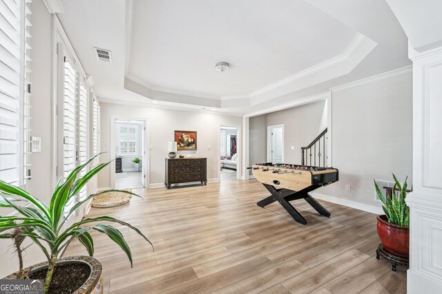 8760 Colonial Pl, Duluth, GA 30097 - exercise room with a raised ceiling, light wood-style floors, crown molding, and baseboards