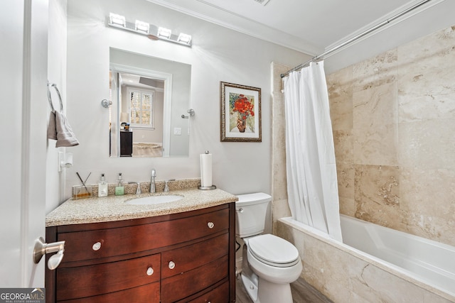 full bathroom featuring toilet, vanity, crown molding, and tiled shower / bath combo