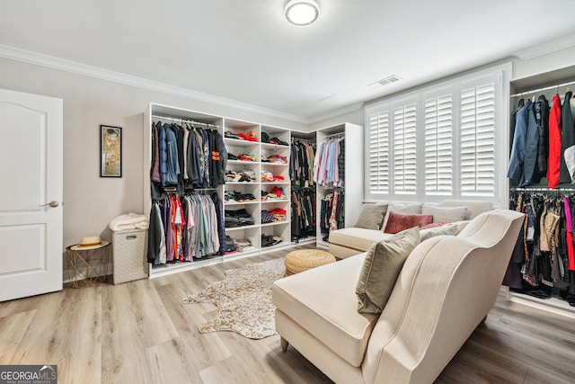 walk in closet featuring wood finished floors and visible vents