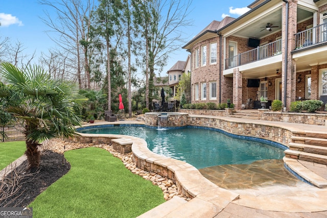 outdoor pool with a patio area, ceiling fan, and fence