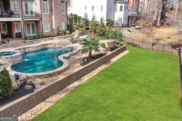 view of swimming pool with fence, a pool with connected hot tub, a yard, french doors, and a patio area