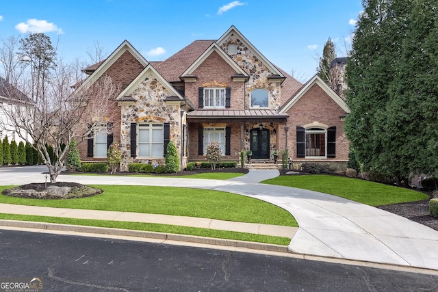 view of front of property with concrete driveway, brick siding, and a front yard