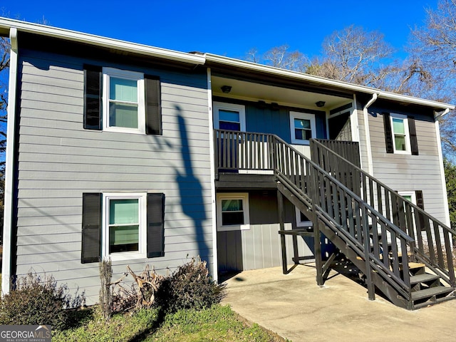 exterior space featuring stairway and a patio