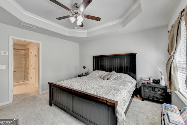 bedroom with a ceiling fan, visible vents, baseboards, a raised ceiling, and light colored carpet