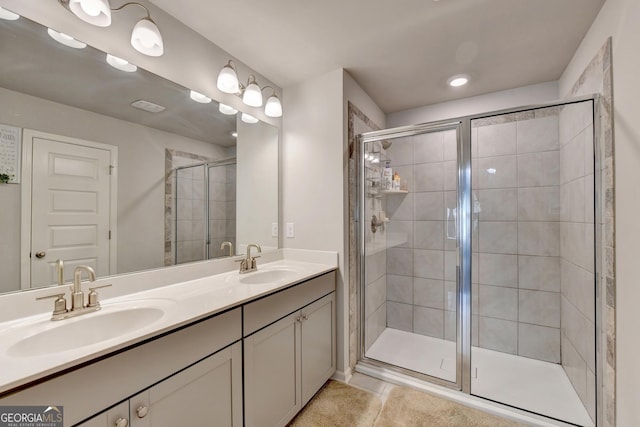 full bathroom featuring tile patterned flooring, a shower stall, double vanity, and a sink