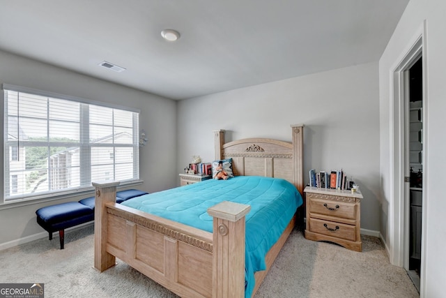 bedroom with visible vents, light colored carpet, and baseboards