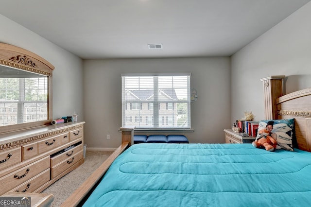 bedroom featuring visible vents, baseboards, and carpet floors