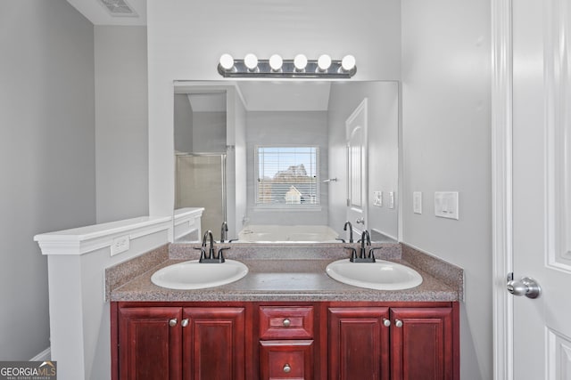 bathroom featuring a stall shower, visible vents, a sink, and a bath