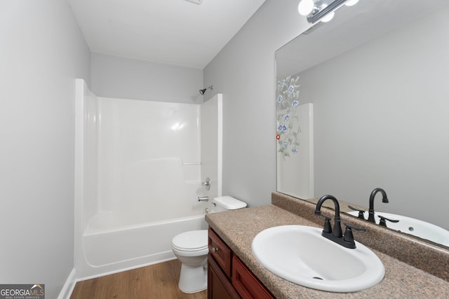 bathroom featuring bathing tub / shower combination, vanity, toilet, and wood finished floors