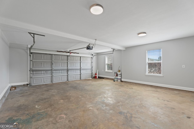 garage featuring a garage door opener and baseboards