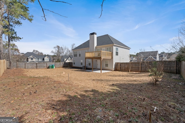 rear view of property with a patio, a chimney, and a fenced backyard