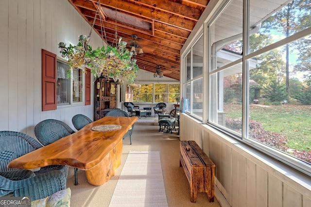 sunroom with a healthy amount of sunlight, wood ceiling, and vaulted ceiling