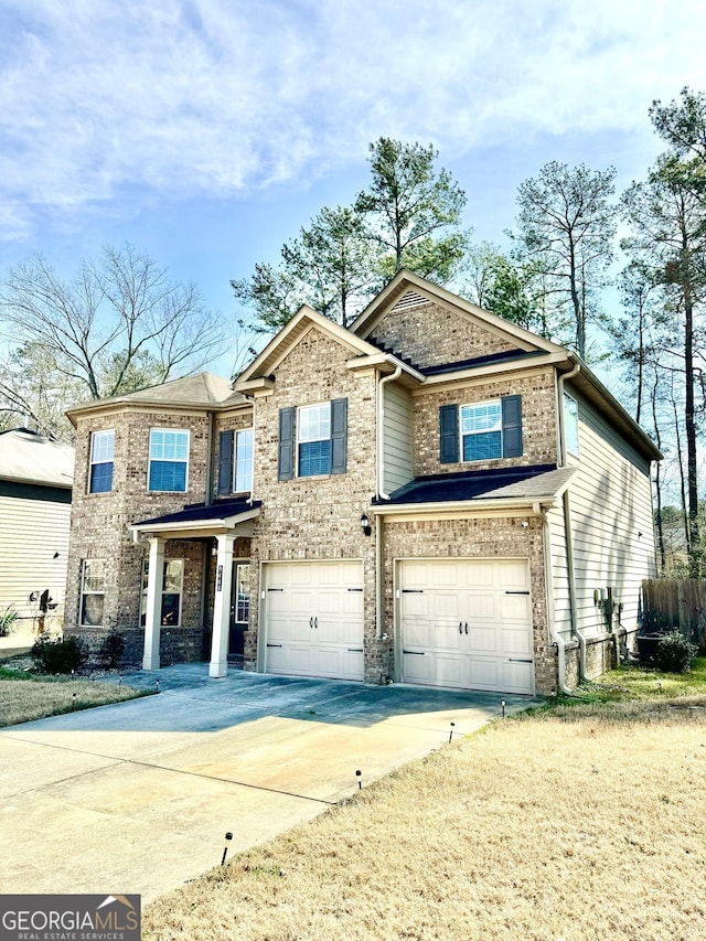 view of front of property featuring an attached garage, concrete driveway, and brick siding