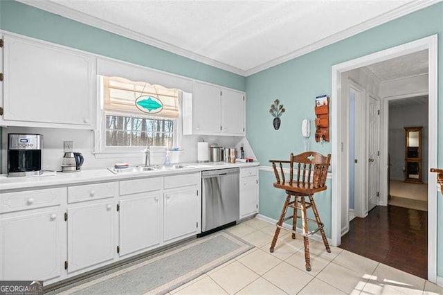 kitchen featuring light countertops, white cabinets, a sink, and stainless steel dishwasher