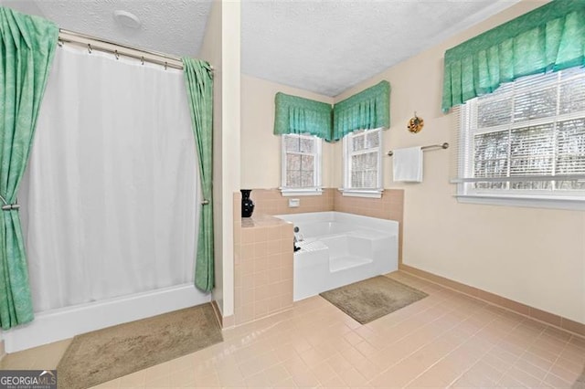 bathroom featuring tile patterned flooring, a textured ceiling, a shower with curtain, and a bath