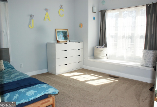 bedroom with carpet floors, visible vents, and baseboards