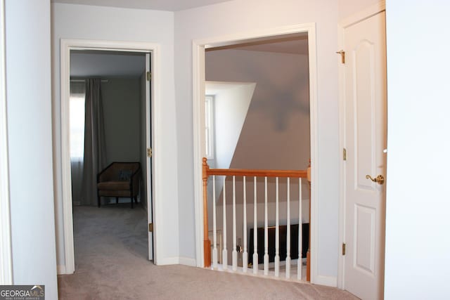 hall with carpet flooring and baseboards