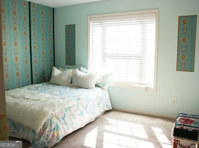 bedroom with carpet and baseboards