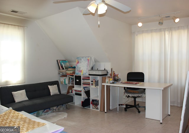 home office featuring vaulted ceiling, visible vents, and a ceiling fan