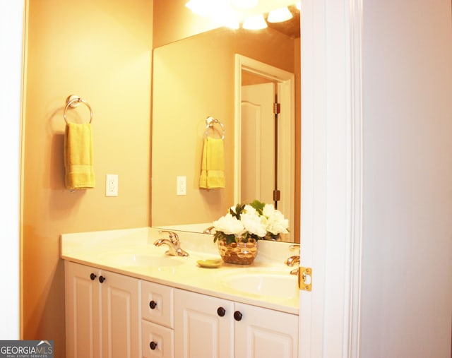 bathroom featuring double vanity and a sink