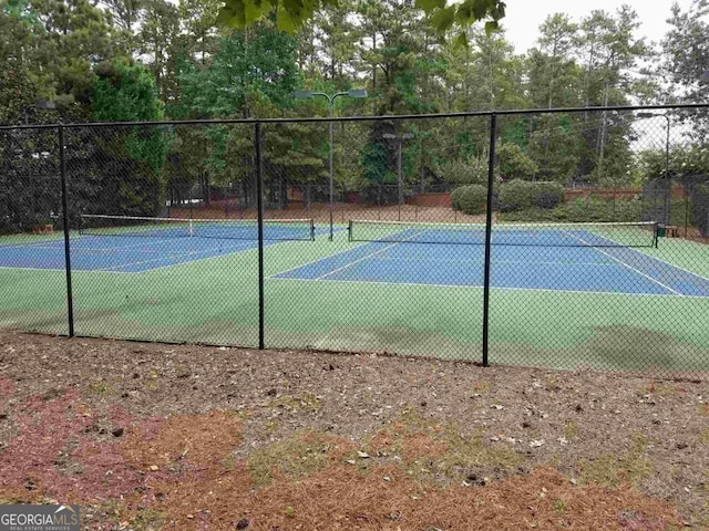 view of sport court with fence