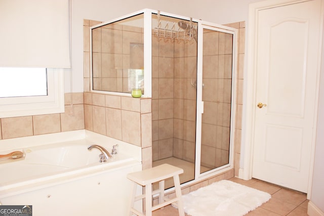 full bathroom with a stall shower, tile patterned flooring, and a garden tub