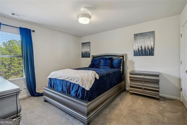 carpeted bedroom featuring baseboards and visible vents