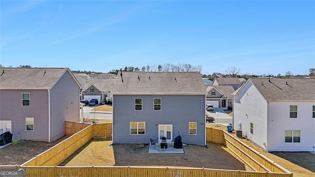 back of property with a patio area, a fenced backyard, and a residential view