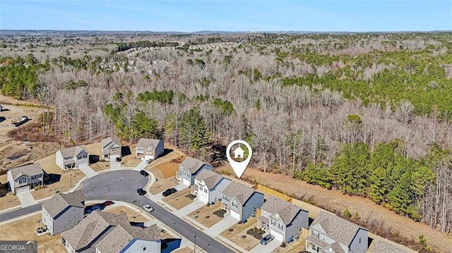 aerial view with a residential view and a view of trees