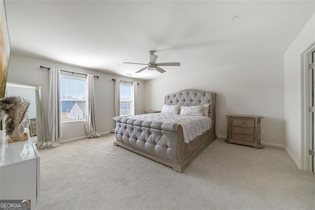 carpeted bedroom featuring ceiling fan and baseboards