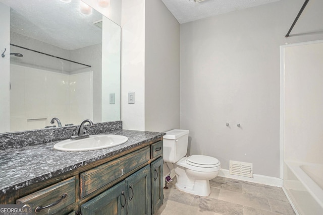 bathroom featuring baseboards, visible vents, toilet, a textured ceiling, and vanity