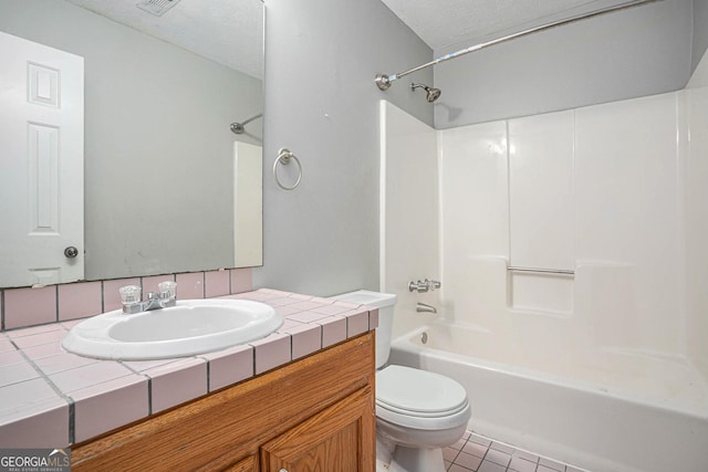 bathroom with toilet, shower / bathing tub combination, a textured ceiling, and vanity