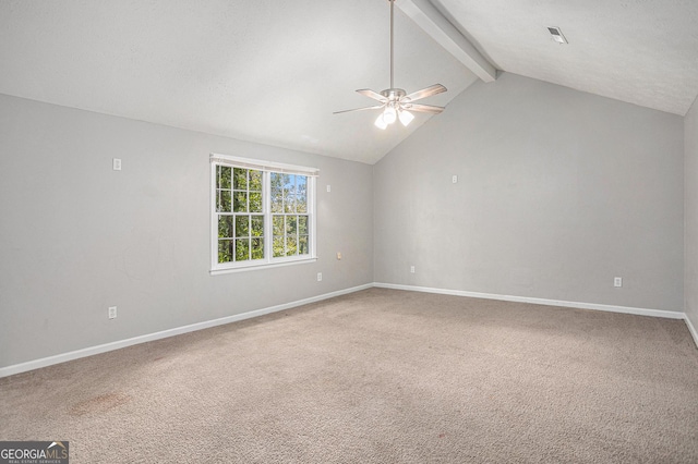 empty room with lofted ceiling with beams, carpet, a ceiling fan, and baseboards