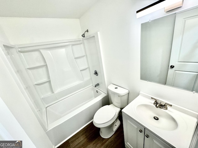 full bath with washtub / shower combination, vanity, wood finished floors, and toilet