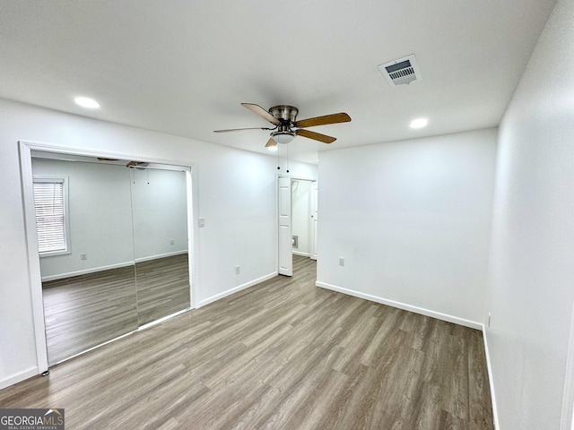 spare room featuring baseboards, visible vents, ceiling fan, wood finished floors, and recessed lighting