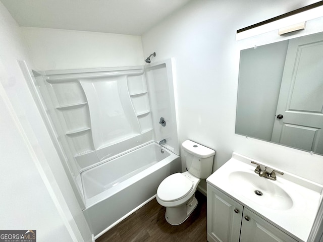 bathroom with bathtub / shower combination, vanity, toilet, and wood finished floors