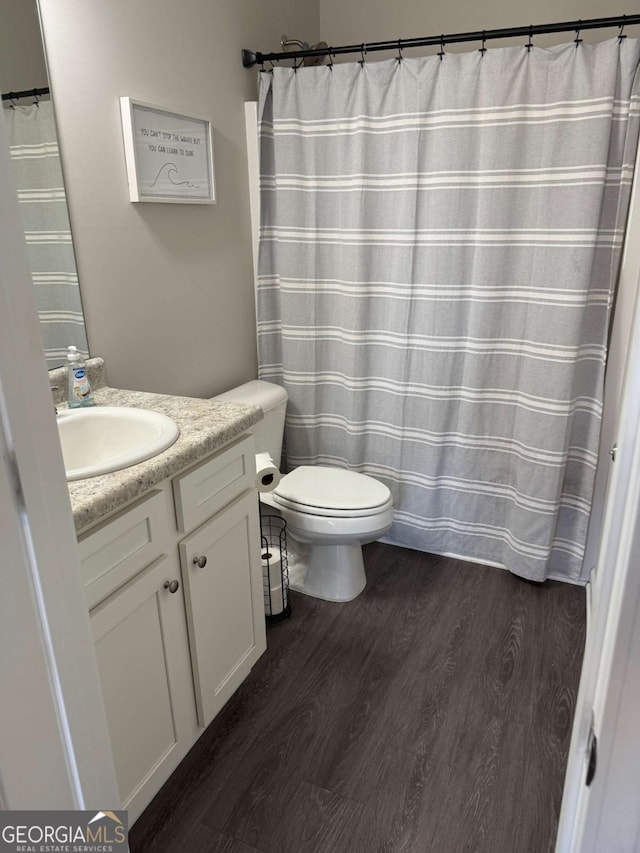 full bath featuring vanity, toilet, and wood finished floors