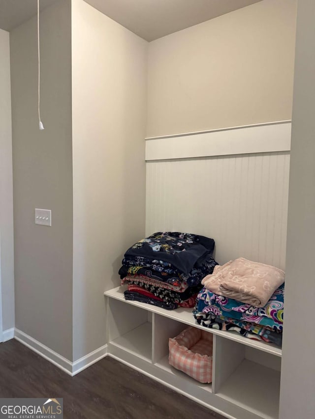 mudroom with dark wood-style floors and baseboards