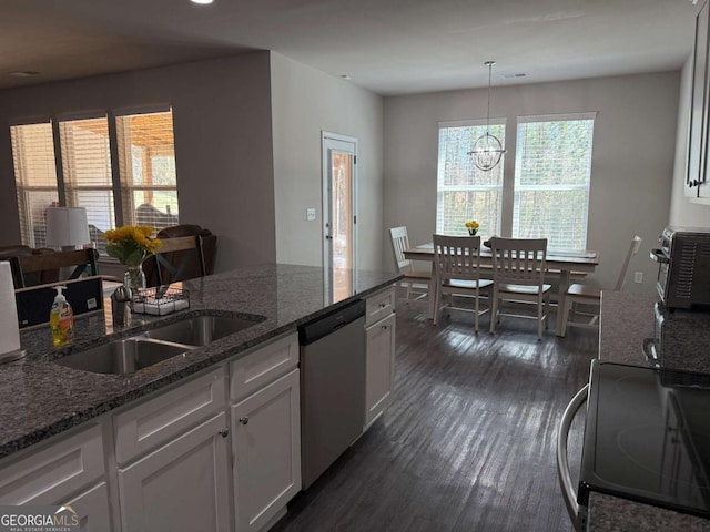 kitchen featuring electric stove, dark stone countertops, dark wood-style flooring, white cabinetry, and stainless steel dishwasher