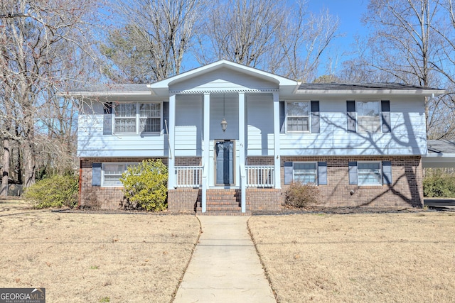 view of front of property featuring covered porch and brick siding